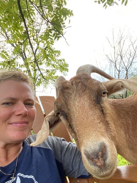 selfie of Deborah with her goat Maverick